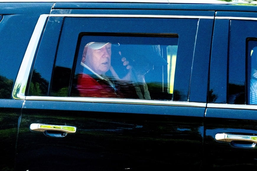 U.S. President Donald Trump talks on the phone as he departs the White House for Trump National Golf Club in Sterling, Virginia, U.S., May 31, 2026. REUTERS/Aaron Schwartz