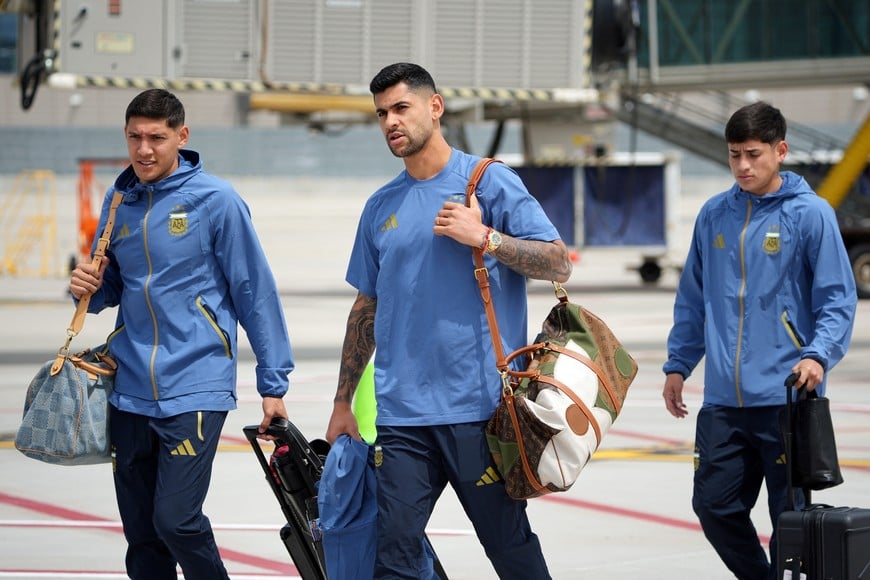 May 31, 2026; Kansas City, Missouri, USA; Nahuel Molina (left), and Cristian Romero (center) of Argentina arrive for the 2026 FIFA World Cup at Kansas City International Airport. Mandatory Credit: Denny Medley-Imagn Images