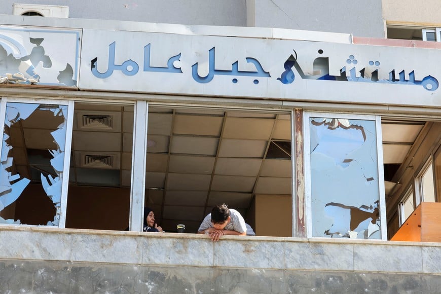 A person looks out of a window at the Jabal Amel Hospital which was damaged in an Israeli strike on Monday, in Tyre, Lebanon, June 2, 2026. REUTERS/Aziz Taher
