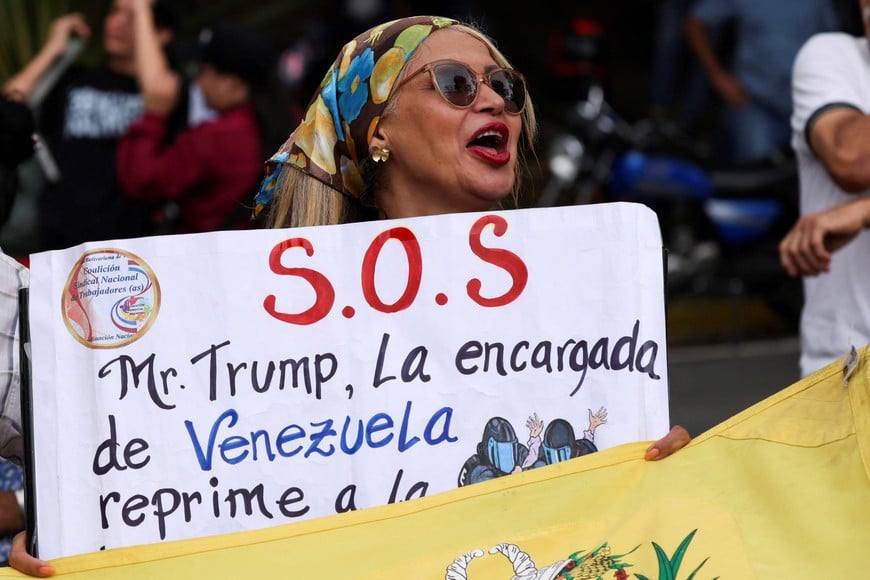 A demonstrator holds a sign during a protest demanding higher wages, better working conditions, and an electoral calendar for the presidential election, in Caracas, Venezuela, June 3, 2026. REUTERS/Leonardo Fernandez Viloria