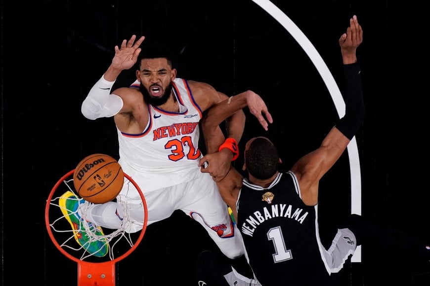 Jun 3, 2026; San Antonio, Texas, USA; New York Knicks center Karl-Anthony Towns (32) shoots the ball over San Antonio Spurs forward Victor Wembanyama (1) during game one of the 2026 NBA Finals at Frost Bank Center. Mandatory Credit: Eric Gay-Pool Photo via Imagn Images