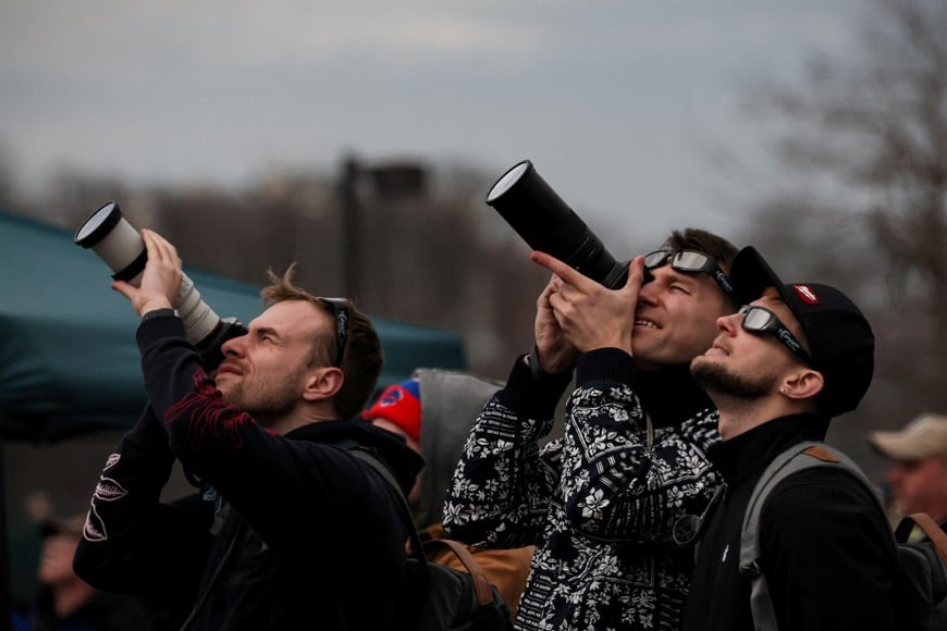 People assemble to view a total solar eclipse, where the moon will blot out the sun, during totality at Niagara Falls, New York, U.S. April 8, 2024. REUTERS/Brendan McDermid