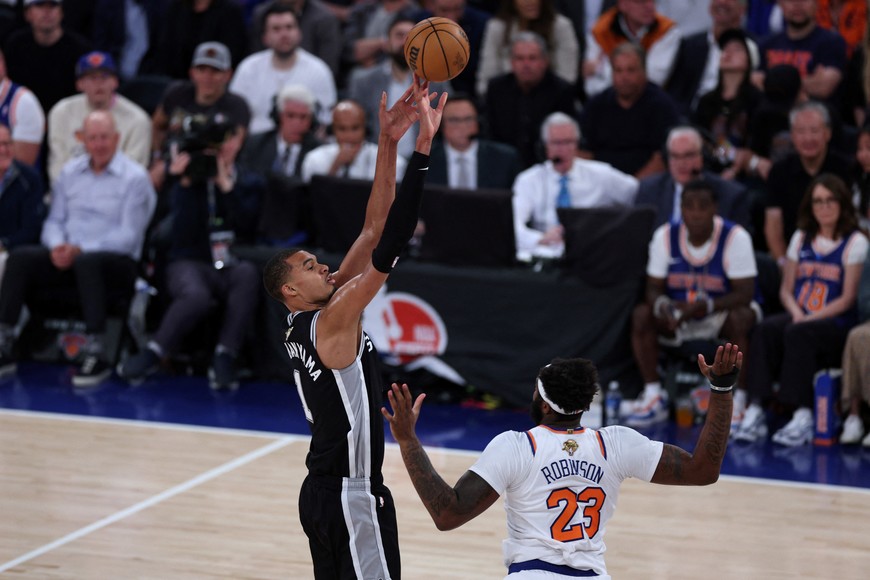 Jun 8, 2026; New York, New York, USA; San Antonio Spurs forward Victor Wembanyama (1) shoots against New York Knicks center Mitchell Robinson (23) in the fourth quarter during game three of the 2026 NBA Finals at Madison Square Garden. Mandatory Credit: Vincent Carchietta-Imagn Images