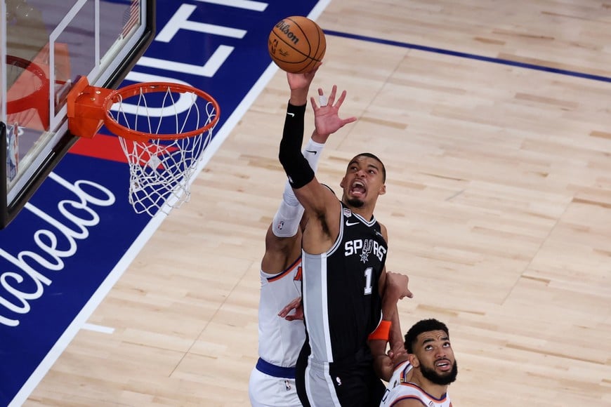 Jun 8, 2026; New York, New York, USA; San Antonio Spurs forward Victor Wembanyama (1) shoots the ball against New York Knicks center Karl-Anthony Towns (32) during game three of the 2026 NBA Finals in the fourth quarter at Madison Square Garden. Mandatory Credit: Wendell Cruz-Imagn Images