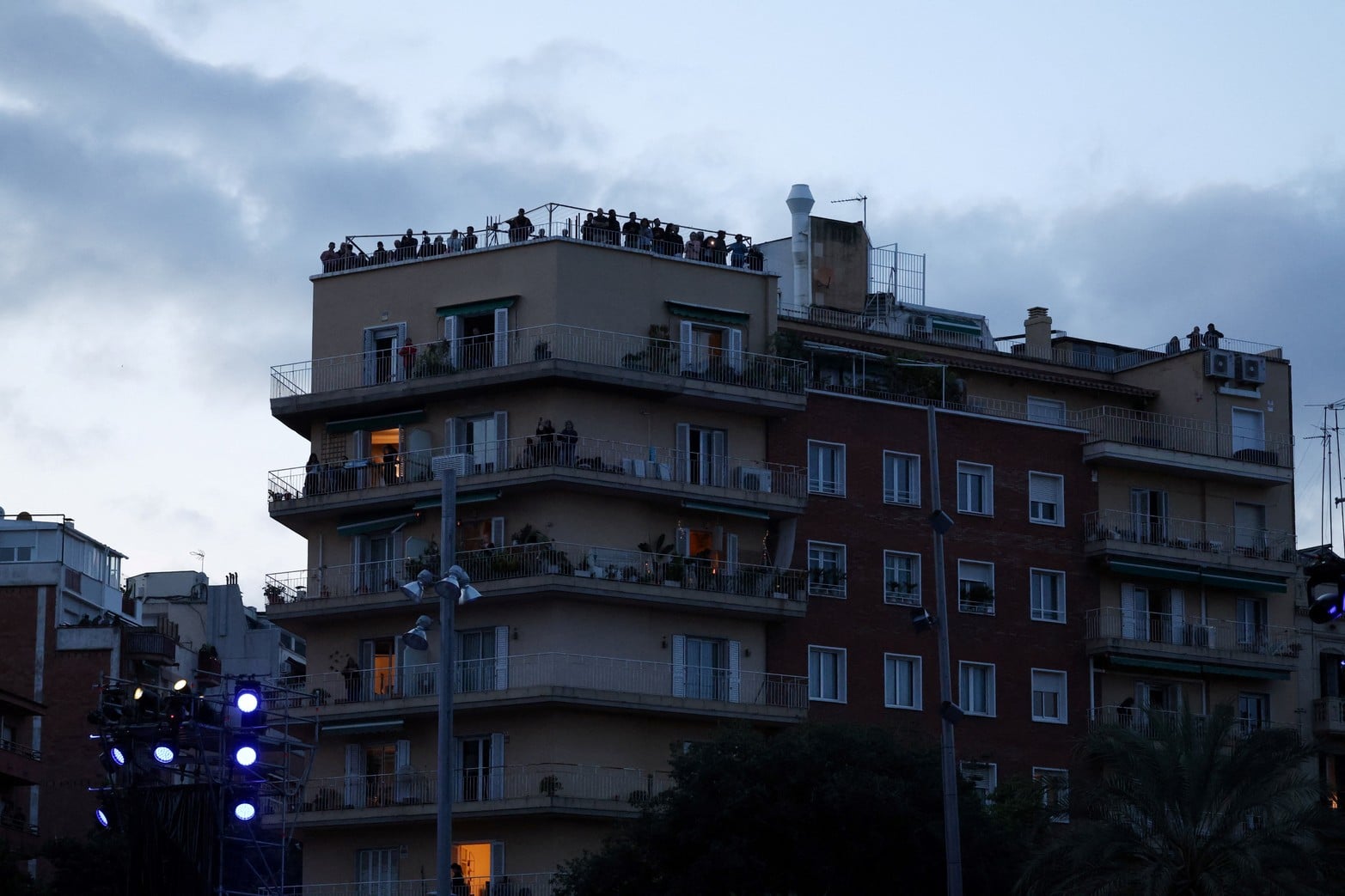 Varias personas, de pie en un edificio cercano, observan la Basílica de la Sagrada Familia tras la Santa Misa oficiada por el Papa León XIV. REUTERS/Bruna Casas
