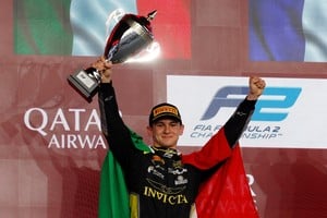Formula One F1 - Qatar Grand Prix - Lusail International Circuit, Lusail, Qatar - November 30, 2025
Leonardo Fornaroli celebrates on the podium with a trophy after winning the Formula 2 title REUTERS/Ibraheem Abu Mustafa