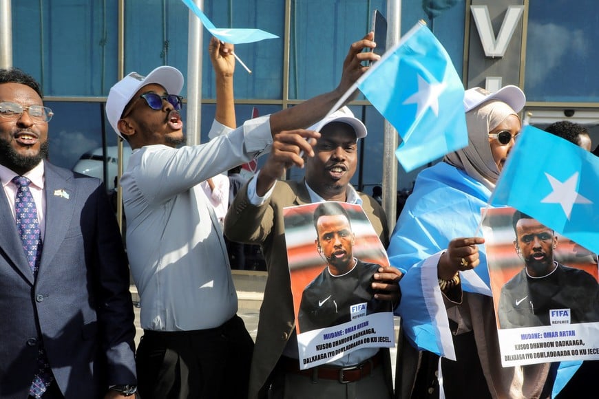 People gather to receive Somali referee Omar Abdulkadir Artan, who had been expected to officiate at matches during the 2026 FIFA World Cup but was denied entry to the United States, as he arrives at the Aden Abdulle Osman International Airport in Mogadishu, Somalia June 10, 2026. REUTERS/Feisal Omar