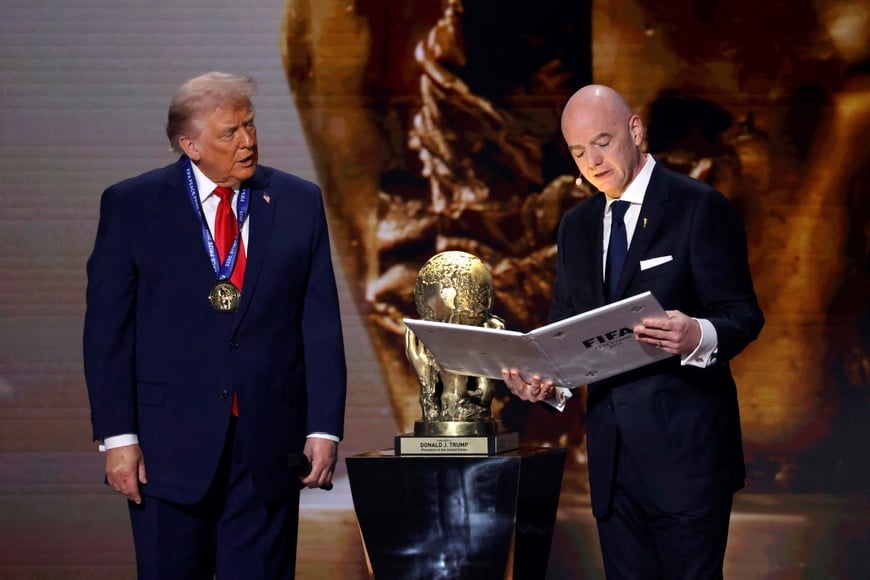 Dec 5, 2025; Washington, District of Columbia, USA; FIFA president Gianni Infantino presents United States President Donald Trump with the FIFA Peace Prize during the FIFA World Cup 2026 Final Draw at John F. Kennedy Center for the Performing Arts. Mandatory Credit: Amber Searls-Imagn Images