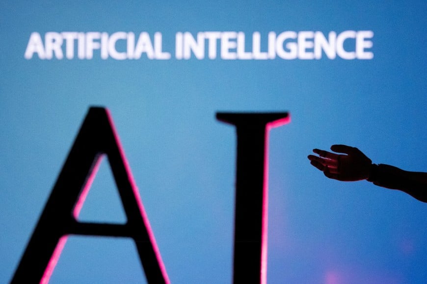 FILE PHOTO: AI (Artificial Intelligence) letters and robot hand miniature in this illustration taken, June 23, 2023. REUTERS/Dado Ruvic/Illustration/File Photo/File Photo