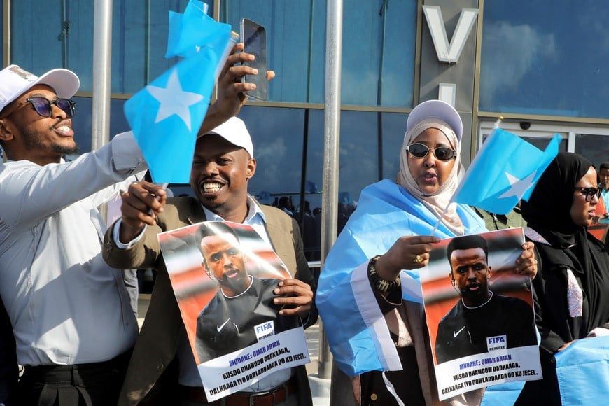 People gather to receive Somali referee Omar Abdulkadir Artan, who had been expected to officiate at matches during the 2026 FIFA World Cup but was denied entry to the United States, as he arrives at the Aden Abdulle Osman International Airport in Mogadishu, Somalia June 10, 2026. REUTERS/Feisal Omar