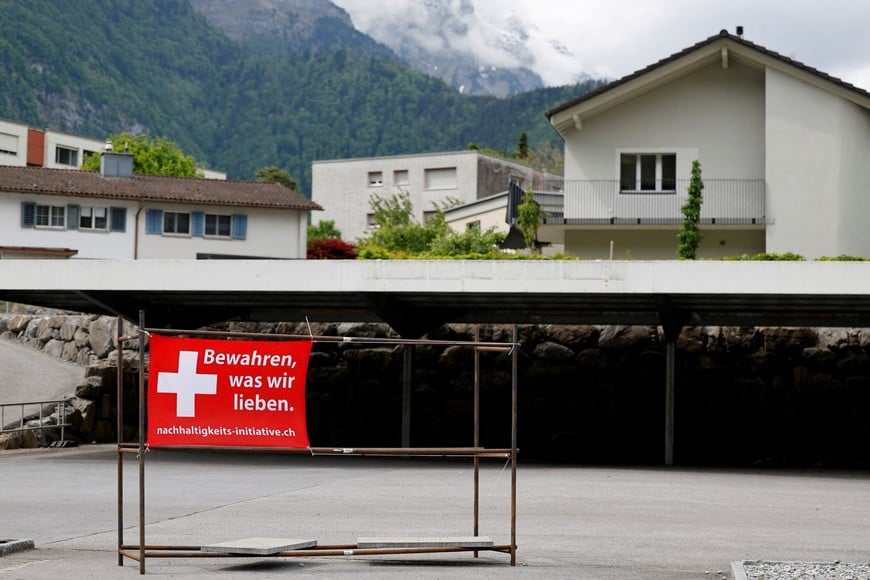 A sign is pictured ahead of a June 14 vote on a plan backed by the right-wing Swiss People's Party (SVP) to cap the population at 10 million inhabitants, in Glarus, Switzerland, May 18, 2026. The sign reads: "Preserve what we love". REUTERS/Stefan Wermuth REFILE - CORRECTING TRANSLATION FROM "PRESERVE WHAT WE HAVE" TO "PRESERVE WHAT WE LOVE".