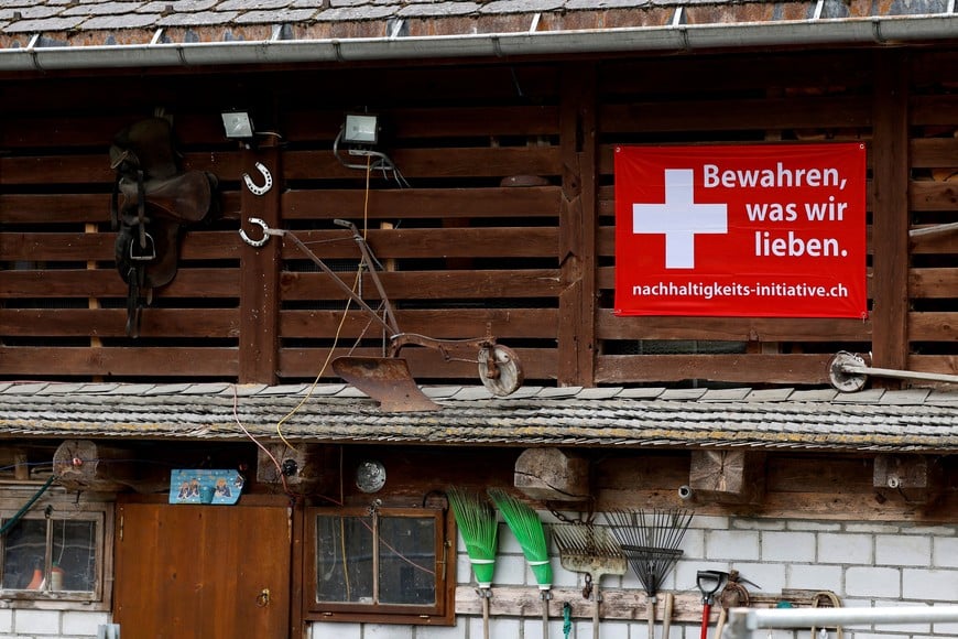 A sign is pictured ahead of a June 14 vote on a plan backed by the right-wing Swiss People's Party (SVP) to cap the population at 10 million inhabitants, in Glarus, Switzerland, May 18, 2026. The sign reads: "Preserve what we love". REUTERS/Stefan Wermuth REFILE - CORRECTING TRANSLATION FROM "PRESERVE WHAT WE HAVE" TO "PRESERVE WHAT WE LOVE".
