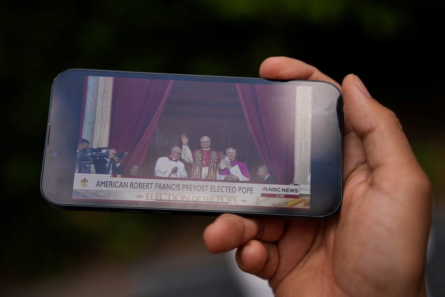 A person watches the news on their phone of the election of  Cardinal Robert Francis Prevost as the new Pope, New York City, U.S. May 8, 2025. REUTERS/Adam Gray