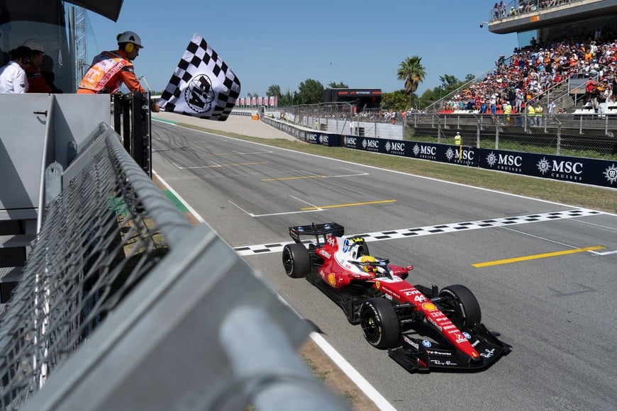 Formula One F1 - Barcelona-Catalunya Grand Prix - Circuit de Barcelona-Catalunya, Barcelona, Spain - June 14, 2026
Ferrari's Lewis Hamilton passes the chequered flag to win the Barcelona-Catalunya Grand Prix Pool via REUTERS/Manaure Quintero