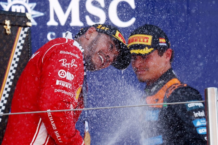 Formula One F1 - Barcelona-Catalunya Grand Prix - Circuit de Barcelona-Catalunya, Barcelona, Spain - June 14, 2026
Ferrari's Lewis Hamilton celebrates on the podium with champagne after winning the Barcelona-Catalunya Grand Prix alongside third placed McLaren's Lando Norris REUTERS/Bruna Casas