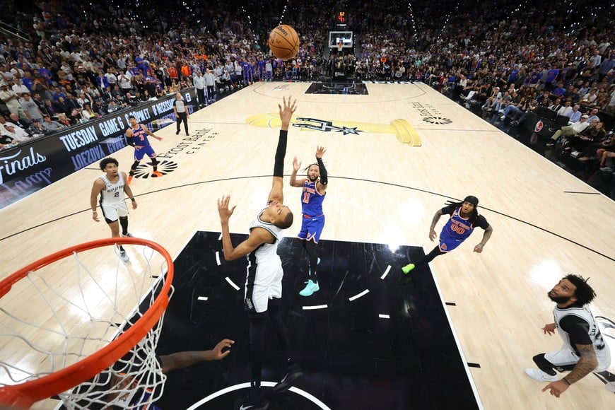 Jun 13, 2026; San Antonio, Texas, USA; New York Knicks guard Jalen Brunson (11) makes a jump shot over San Antonio Spurs forward Victor Wembanyama (1) during game five of the 2026 NBA Finals at Frost Bank Center. Mandatory Credit: Geoff Burke-Pool Photo via Imagn Images