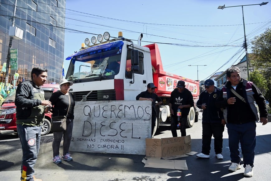 Truck drivers protest next to a sign reading "We want diesel, two weeks sleeping" while waiting in line with their trucks, as protests have caused supply chain disruptions in the cities of La Paz and El Alto, leading to severe shortages of food, fuel and medicine, in La Paz, Bolivia, June 15, 2026. REUTERS/Claudia Morales