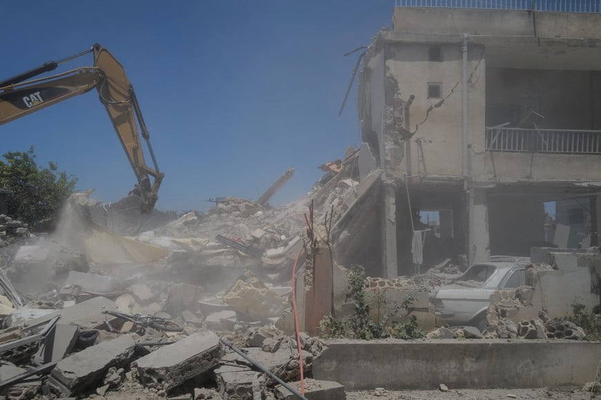 A machine works at the site of an Israeli air strike on a house as rescuers try to recover bodies from under the rubble, in Barish, in Tyre district, Lebanon June 20, 2026. REUTERS/Zohra Bensemra