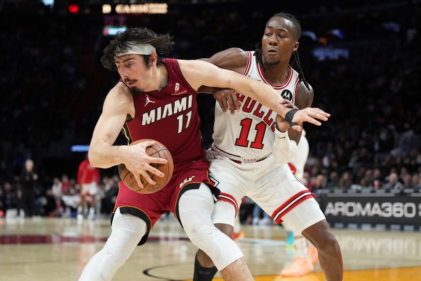 Jan 31, 2026; Miami, Florida, USA; Miami Heat forward Jaime Jaquez Jr. (11) battles with Chicago Bulls guard Ayo Dosunmu (11) during the second half at Kaseya Center. Mandatory Credit: Jim Rassol-Imagn Images