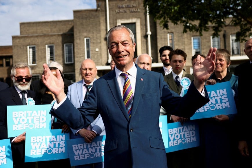 Britain's Reform UK leader Nigel Farage reacts next to newly elected councillors at the Havering Town Hall, following the results of the local elections, in the London Borough of Havering, Britain, May 8, 2026. REUTERS/Jack Taylor