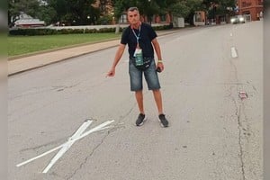 El enviado de El Litoral en el exacto lugar del segundo balazo que terminó con la vida de John Kennedy, en Dallas. Está marcado con una cruz en la calle. Y de fondo, se observa el lugar desde que salió el disparo. En el penúltimo piso, es la última ventana de la derecha.