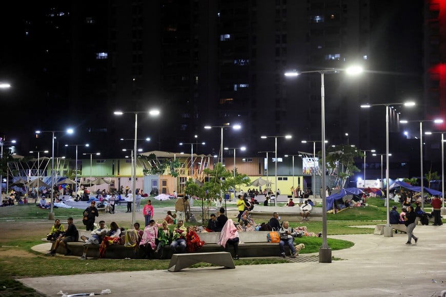 People rest in a square out of fear of going back into buildings, as emergency services (not pictured) work at the site of a collapsed building after earthquakes hit the country, in Caracas, Venezuela, June 25, 2026. REUTERS/Leonardo Fernandez Viloria