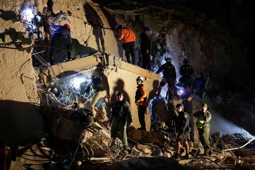 Emergency services work at the site of a collapsed building after earthquakes hit the country, in Caracas, Venezuela, June 24, 2026. REUTERS/Gaby Oraa