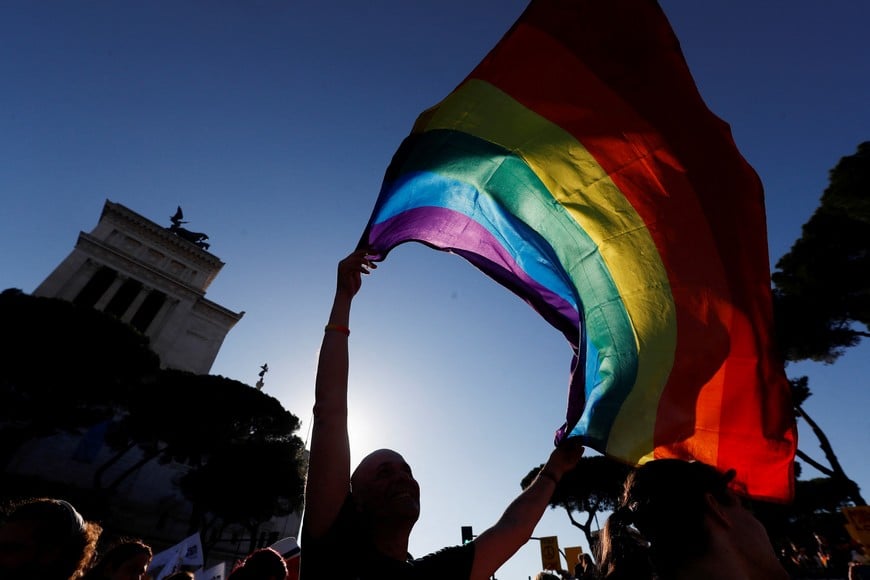 A person carries a rainbow-coloured flag while attending an LGBTQ+ Pride parade in Rome, Italy, June 11, 2022. REUTERS/Yara Nardi