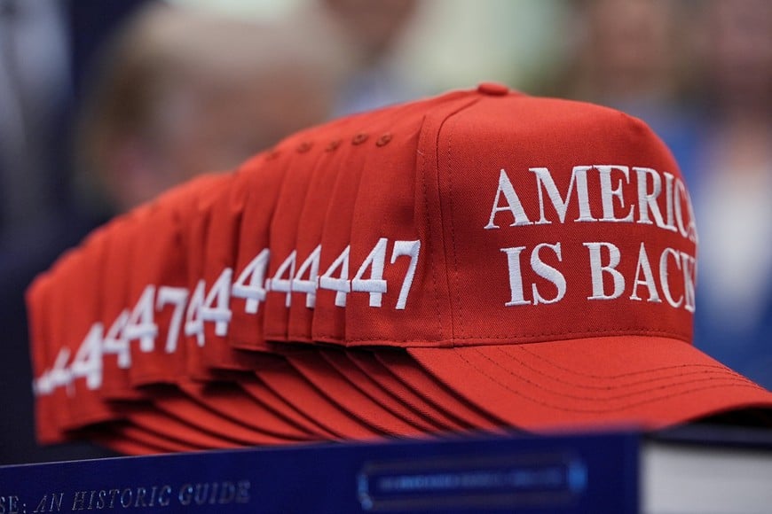 Caps reading "America is back", as U.S. President Donald Trump receives the report from his Religious Liberty Commission in the Oval Office of the White House in Washington, D.C., U.S., June 26, 2026. REUTERS/Ken Cedeno
