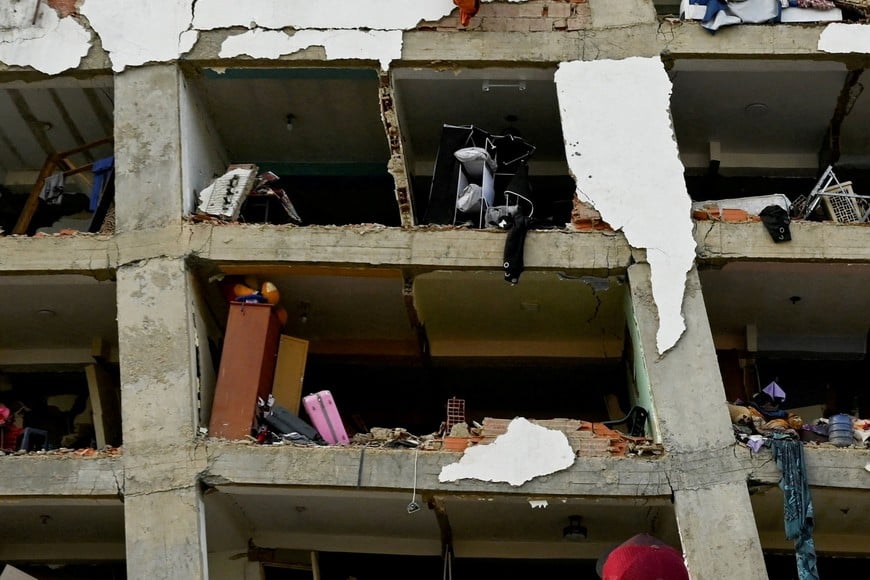 A man looks at a damaged building in the aftermath of earthquakes in La Guaira, Venezuela, June 25, 2026. REUTERS/Maxwell Briceno