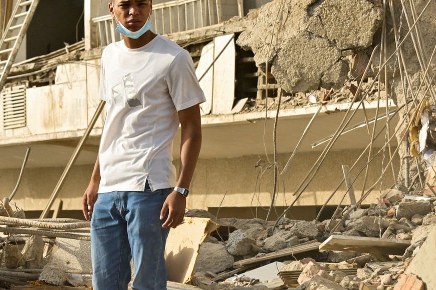 A man stands amid the rubble of collapsed buildings, in the aftermath of earthquakes in La Guaira, Venezuela, June 25, 2026. REUTERS/Maxwell Briceno