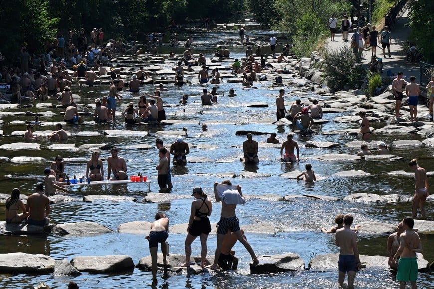 People enjoy the water of the Dreisam river at the so called water terraces in Freiburg, Germany, June 27, 2026, as temperatures in parts of the country are expected to raise to over a 40 C record high this weekend.   REUTERS/Anne Ackermann