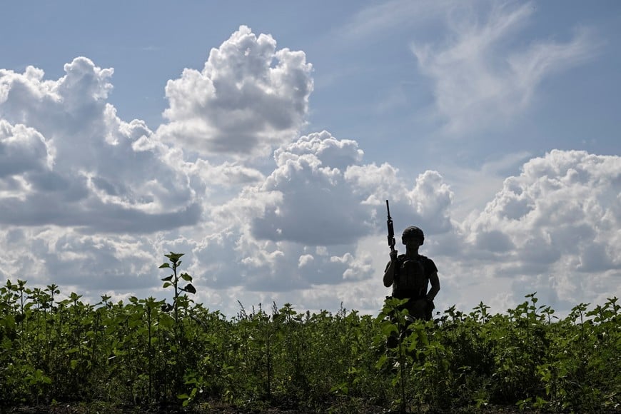 A serviceman of the 148th Separate Artillery Zhytomyr Brigade of the Armed Forces of Ukraine walks at a position on the front line, amid Russia's attack on Ukraine, in Dnipropetrovsk region, Ukraine June 23, 2026. REUTERS/Stringer
