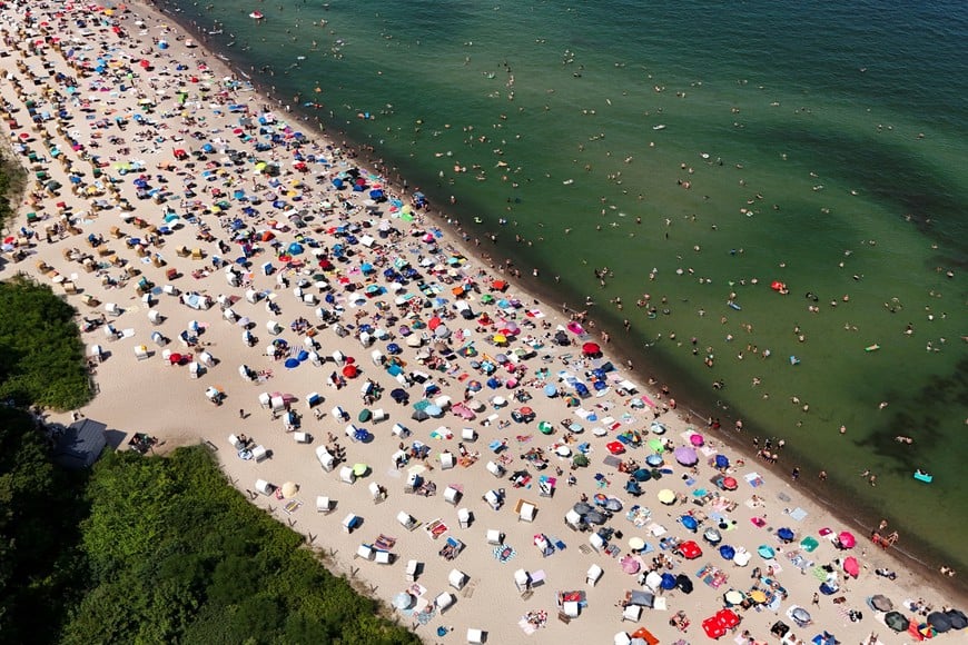 A drone view shows people at a beach as meteorologists forecast heat and record-breaking temperatures across the country in Timmendorfer Strand, Germany, June 27, 2026. REUTERS/Jonas Walzberg