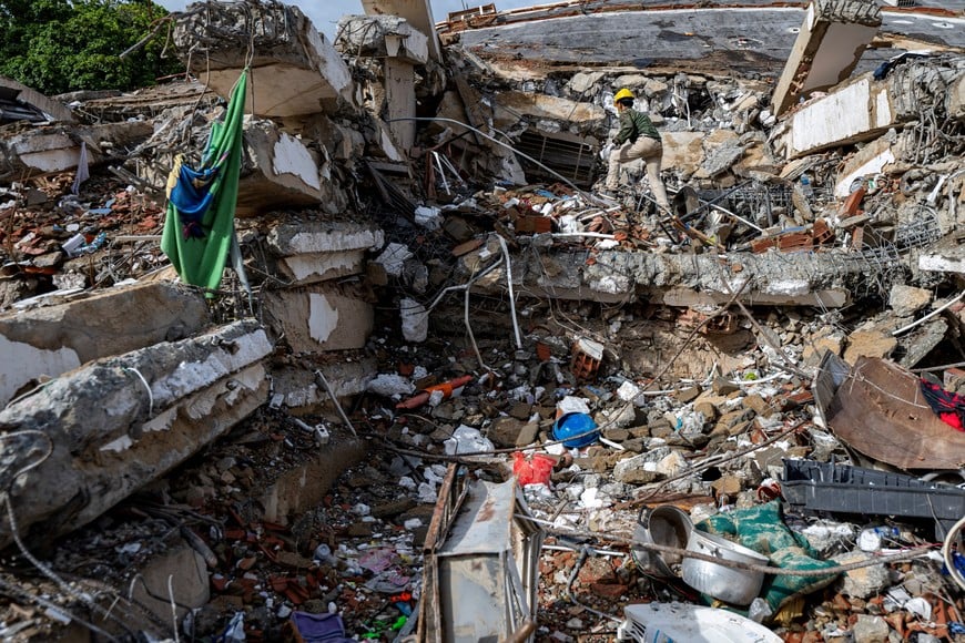 A volunteer climbs over the rubble at the site of a collapsed building in Caraballeda, La Guaira state, Venezuela, June 30, 2026, in the aftermath of earthquakes. MIGUEL MEDINA/Pool via REUTERS
