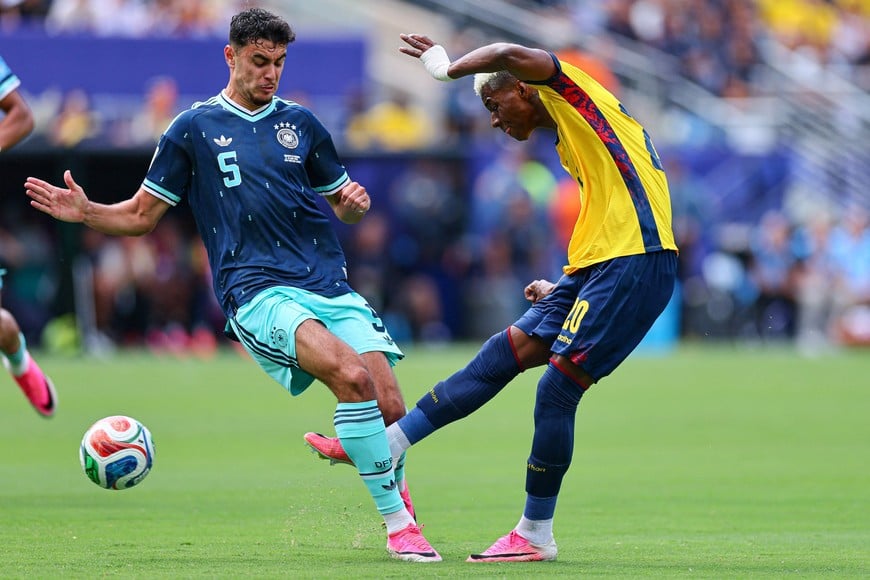 Jun 25, 2026; East Rutherford, New Jersey, USA; Ecuador forward Nilson Angulo (20) scores a goal as Germany midfielder Aleksandar Pavlovic (5) defends during a Group E match of the 2026 FIFA World Cup at New York New Jersey Stadium. Mandatory Credit: Vincent Carchietta-Imagn Images