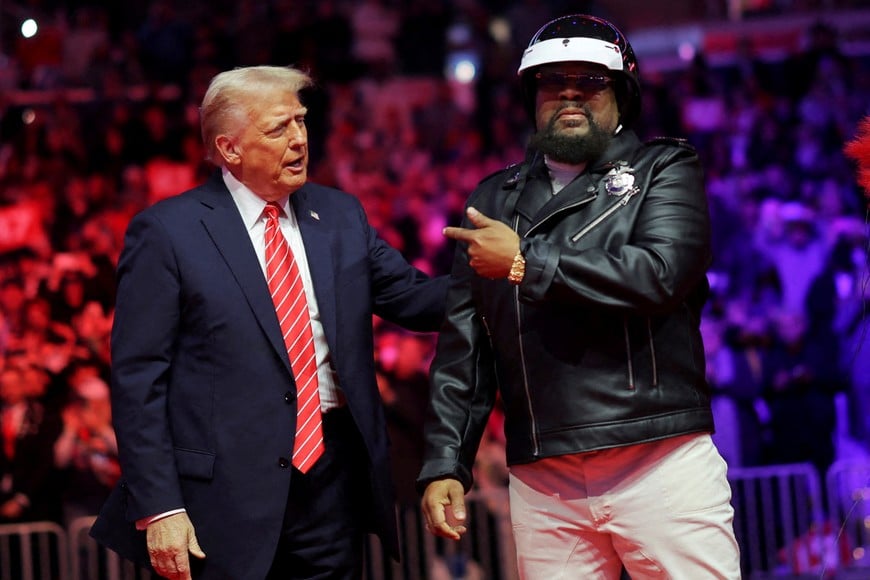 U.S. President-elect Donald Trump stands next to Victor Willis, member of the Village People during a rally the day before he is scheduled to be inaugurated for a second term, in Washington, U.S., January 19, 2025. REUTERS/Carlos Barria