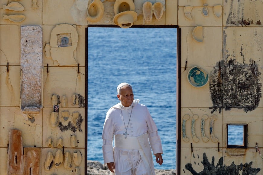 Pope Leo stops at "Porta d’Europa" memorial, with an Italian Coast Guard vessel sailing in the background, as he visits the island of Lampedusa, a key entry point for migrants crossing the Mediterranean Sea, during a pastoral trip, Italy, July 4, 2026. REUTERS/Remo Casilli