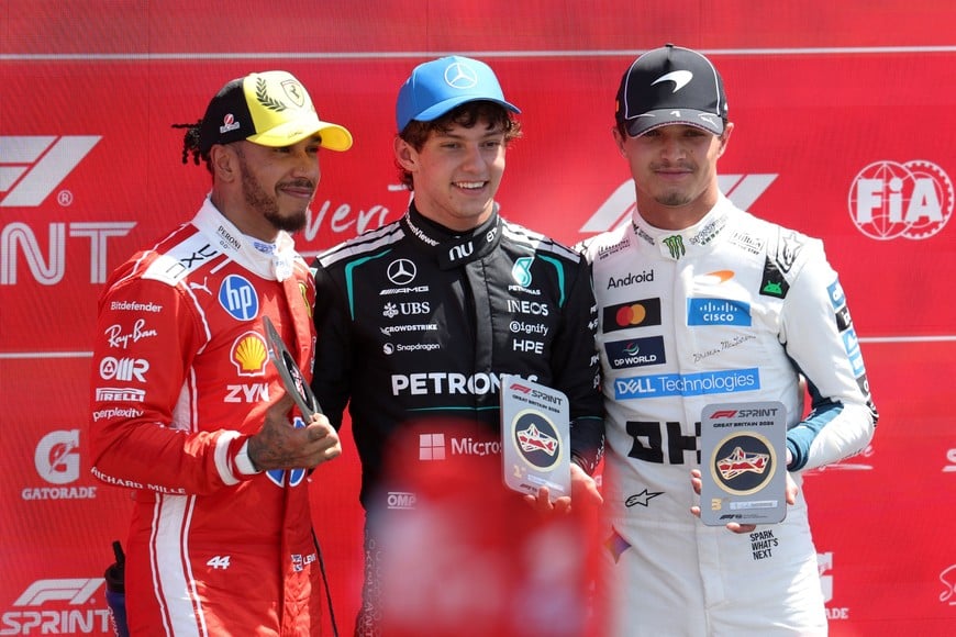 Formula One F1 - British Grand Prix - Silverstone Circuit, Silverstone, Britain - July 4, 2026
Mercedes' Andrea Kimi Antonelli celebrates with Ferrari's Lewis Hamilton and McLaren's Lando Norris after winning the sprint race REUTERS/Suzanne Plunkett