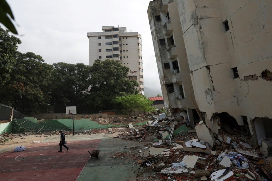 A man walks next to a damaged building in the aftermath of the June 24 earthquakes, in La Guaira, Venezuela, July 4, 2026. REUTERS/Pablo Sanhueza