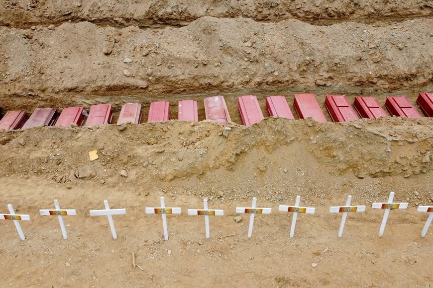 A drone view of coffins on the day of the burial of earthquake victims, in the aftermath of the June 24 earthquakes, at La Esperanza Cemetery, in La Guaira, Venezuela, July 6, 2026. REUTERS/Adriano Machado