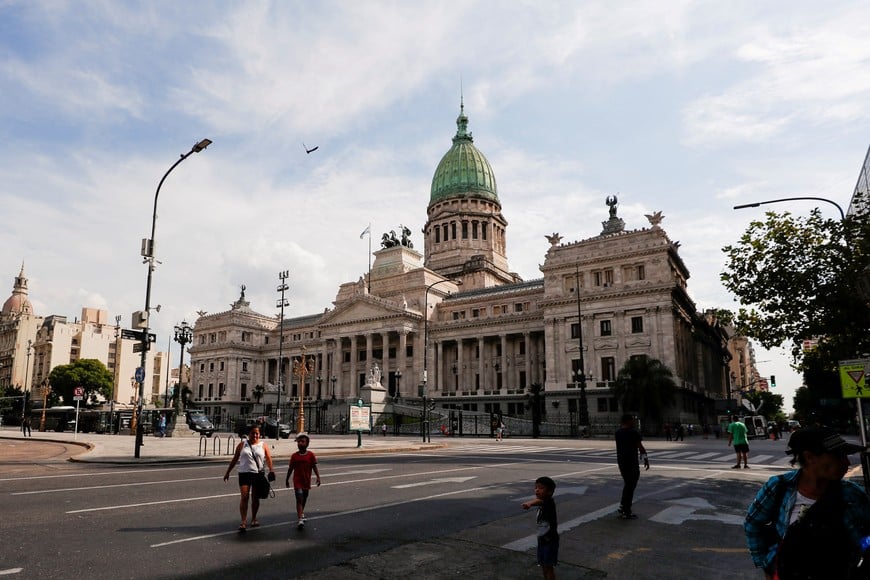 FILE PHOTO: People walk outside the National Congress, as the senate debates the government's agreement with the International Monetary Fund (IMF) in Buenos Aires, Argentina March 17, 2022. REUTERS/Agustin Marcarian/File Photo