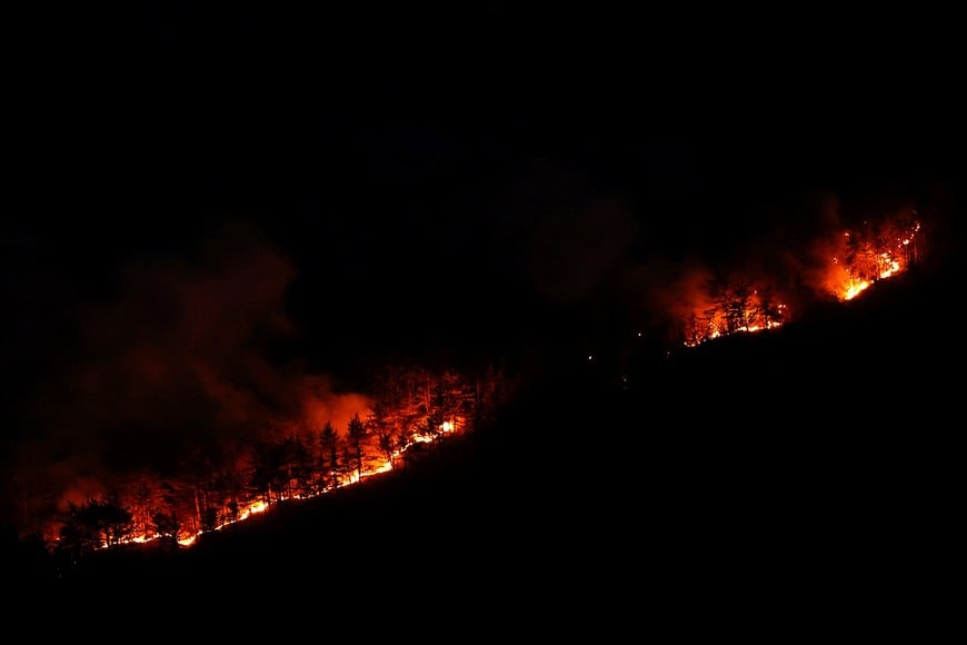 Flames rise from a wildfire that has been ravaging mountain vegetation for several days, during a heatwave affecting a large part of the country, at night near Die in the Drome department, France, July 9, 2026. REUTERS/Manon Cruz