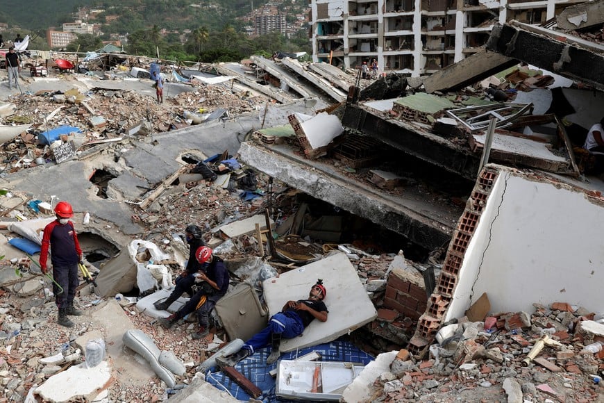A rescuer takes a break on a mattress amidst the rubble of a collapsed building following the June 24 earthquakes, in La Guaira, Venezuela, July 10, 2026. REUTERS/Pablo Sanhueza
