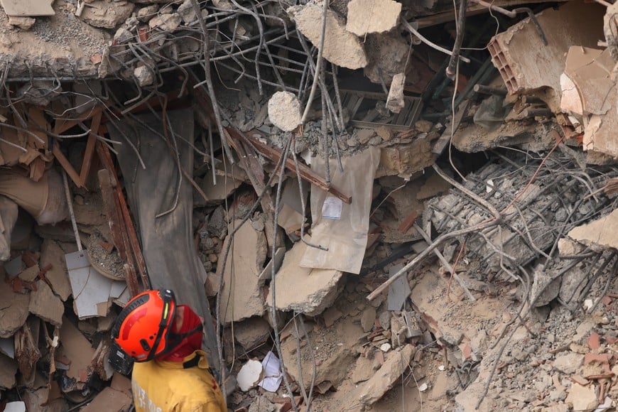 A rescuer searches through debris, in the aftermath of the June 24 earthquakes in Caraballeda, La Guaira state, Venezuela, July 9, 2026. REUTERS/Leonardo Fernandez Viloria