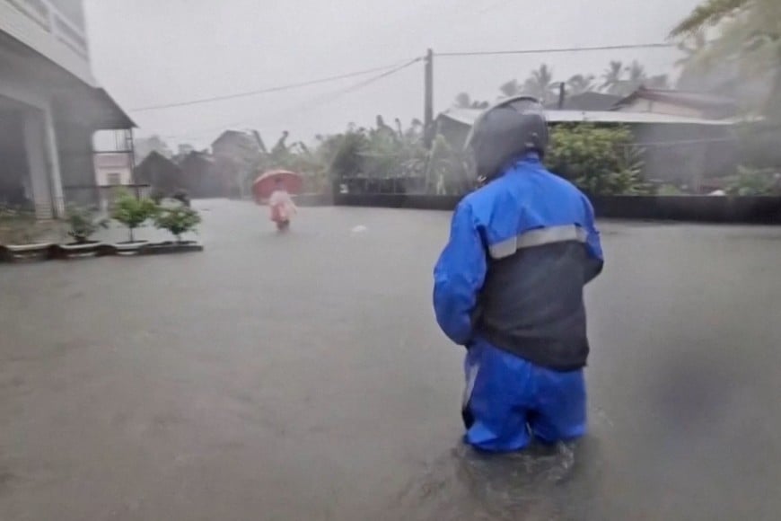 People stand in the floodwater during heavy rains caused by the nearby passing of typhoon Mekkhala, as it heads towards Japan, in Pingtung, Taiwan, June 25, 2026, in this screen grab taken from a video. CTS via REUTERS TV/via REUTERS THIS IMAGE HAS BEEN SUPPLIED BY A THIRD PARTY. NO RESALES. NO ARCHIVES. TAIWAN OUT. NO COMMERCIAL OR EDITORIAL SALES IN TAIWAN. MANDATORY CREDIT.