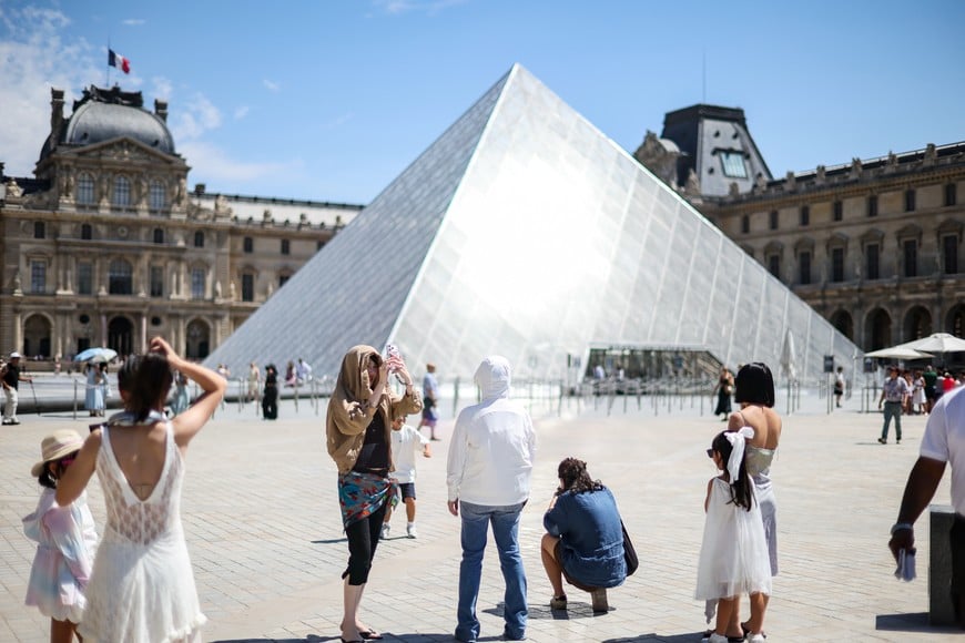 (260710) -- PARIS, 10 julio, 2026 (Xinhua) -- Personas son vistas cerca del Museo de Louvre durante la ola de calor, en París, Francia, el 10 de julio de 2026. El Museo de Louvre anunció el jueves que cerrará dos horas antes de lo habitual desde el viernes hasta el próximo lunes mientras Francia se prepara para otra ola de calor. (Xinhua/Wu Huiwo) (jg) (ra) (vf)
