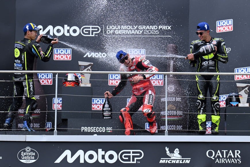 MotoGP - German Grand Prix - Sachsenring, Hohenstein-Ernstthal, Germany - July 12, 2026
Ducati Lenovo Team's Marc Marquez celebrates on the podium after winning the MotoGP race along with runner up Trackhouse MotoGP Team's Ai Ogura and third placed Trackhouse MotoGP Team's Raul Fernandez REUTERS/Annegret Hilse
