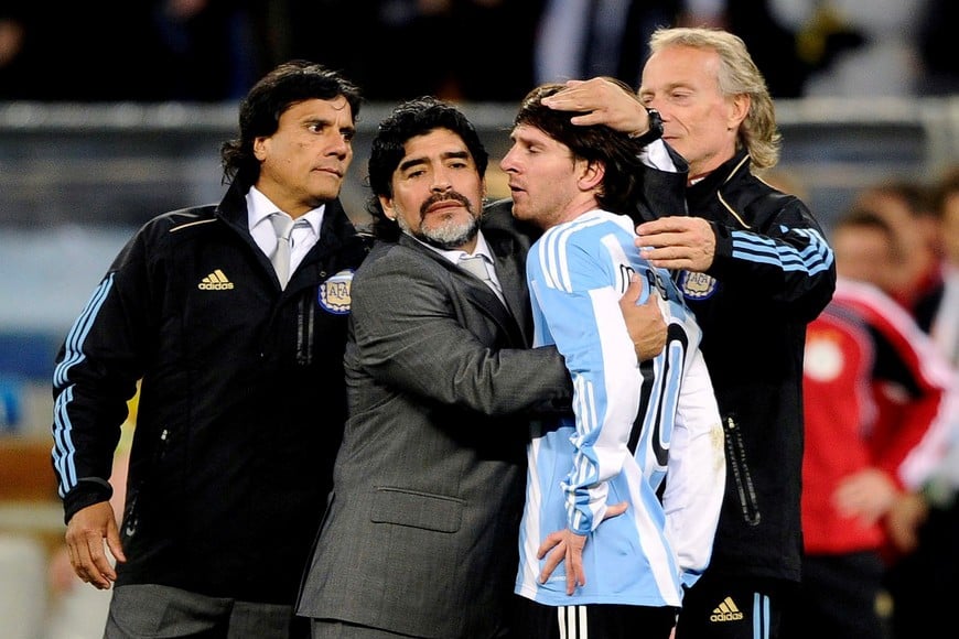 FILE PHOTO: Argentina's coach Diego Maradona hugs Lionel Messi after Germany won their 2010 World Cup quarter-final soccer match at Green Point stadium in Cape Town July 3, 2010. REUTERS/Dylan Martinez (SOUTH AFRICA - Tags: SPORT SOCCER WORLD CUP) - LM2E6731BBP01/File Photo