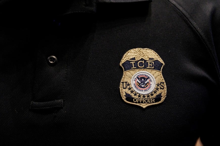FILE PHOTO: The badge of a U.S. Immigration and Customs Enforcement (ICE) is embroidered on a polo shirt of an ICE employee, at a U.S. Immigration and Customs Enforcement two-day job fair in Texas to help fill vacancies for deportation officers and attorneys, in Arlington, Texas, U.S. August 26, 2025. REUTERS/Shelby Tauber/File Photo